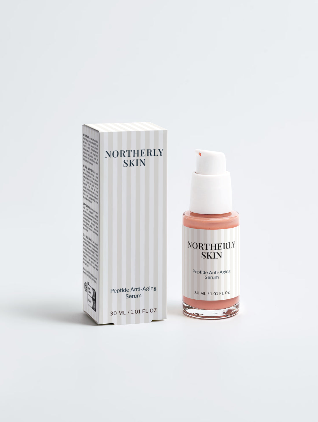 The serum bottle beside its striped carton