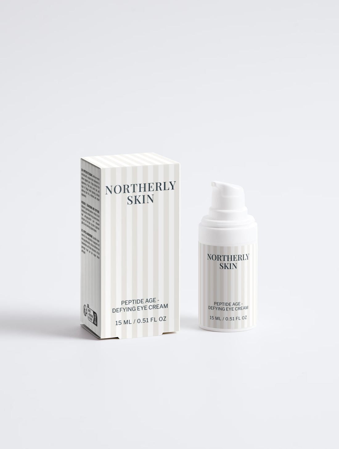 The eye cream bottle beside its striped carton