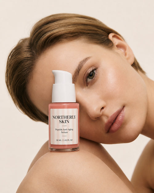 A woman resting her cheek against the 30 ml Northerly Skin serum bottle